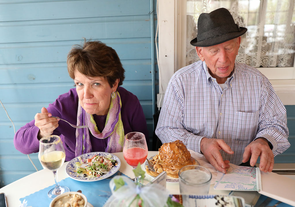 Leslie Goodman, left, and Jack Walts eat lunch before taking cruise tour